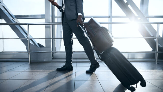 Business Trip. Businessman Moving to Terminal Gate at International Airport